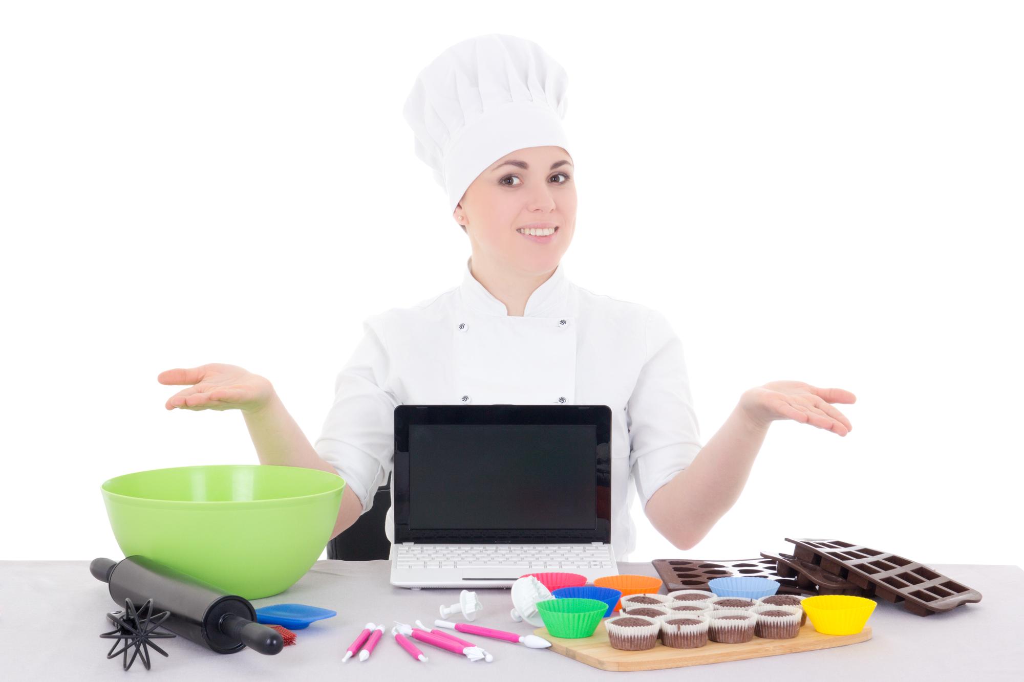 Student working on a plated dish in a compact studio kitchen