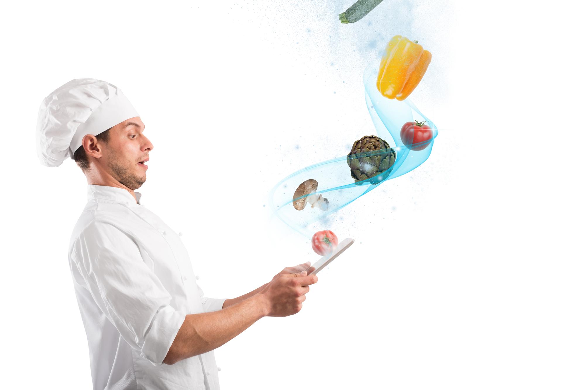 Chef demonstrating a modern technique in futuristic kitchen